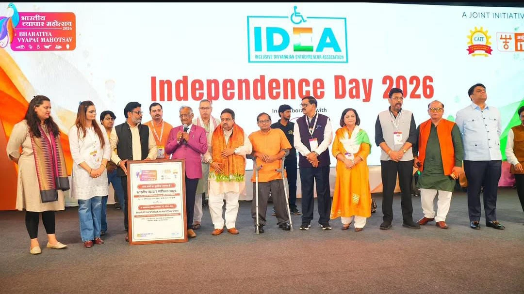 Group of participants on stage at a Bhartiya Vyapar Mahotsav event with an inclusion and entrepreneurship backdrop