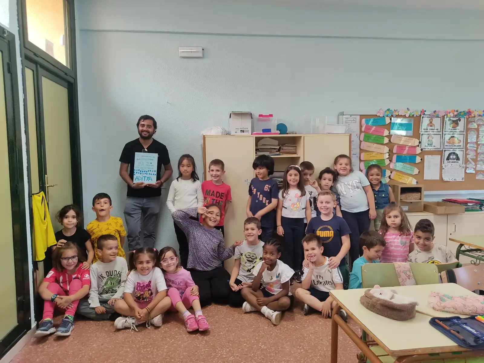 Aditya Sarin with a group of Spanish students in a classroom